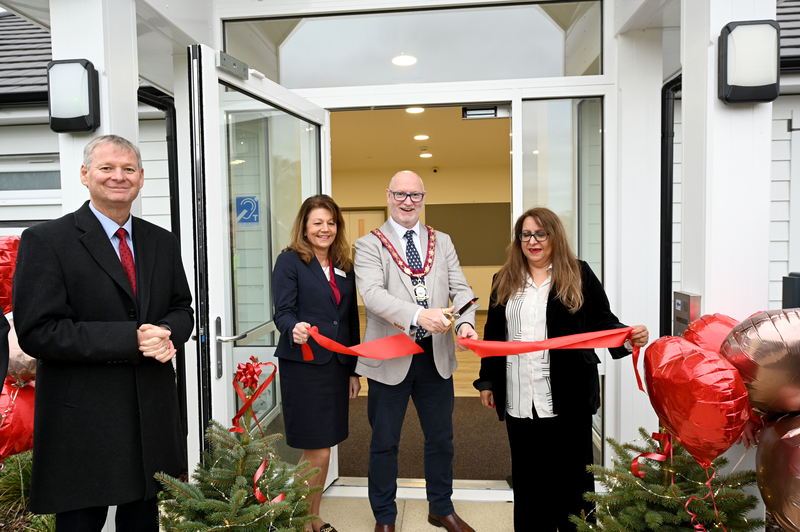 Cutting the ribbon at the entrance of the new community centre