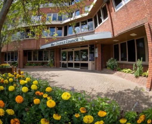 The front of Hart District Council's offices with yellow flowers in foreground