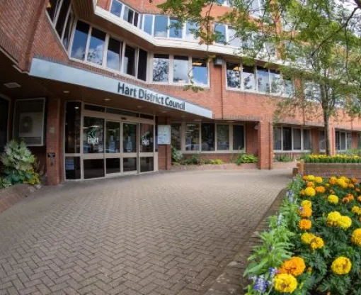 Hart District Council office entrance with orange and yellow flowers in foreground