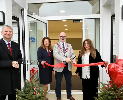 Cutting the ribbon at the entrance of the new community centre