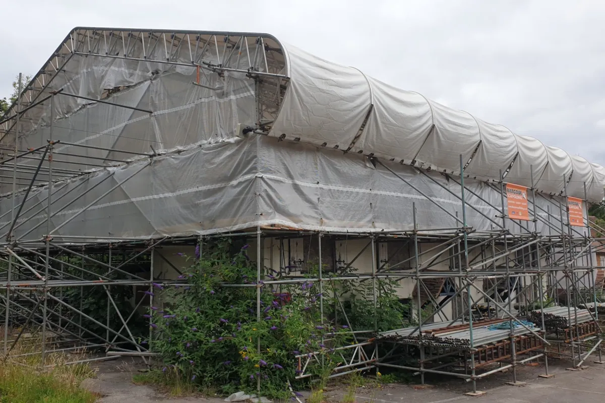 Building with roof covered in plastic