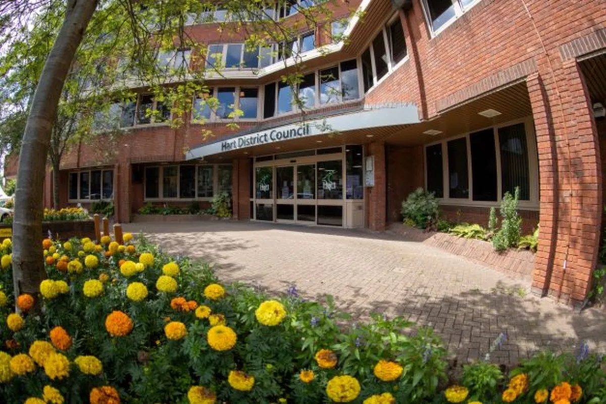 Red brick building with yellow flowers in foreground