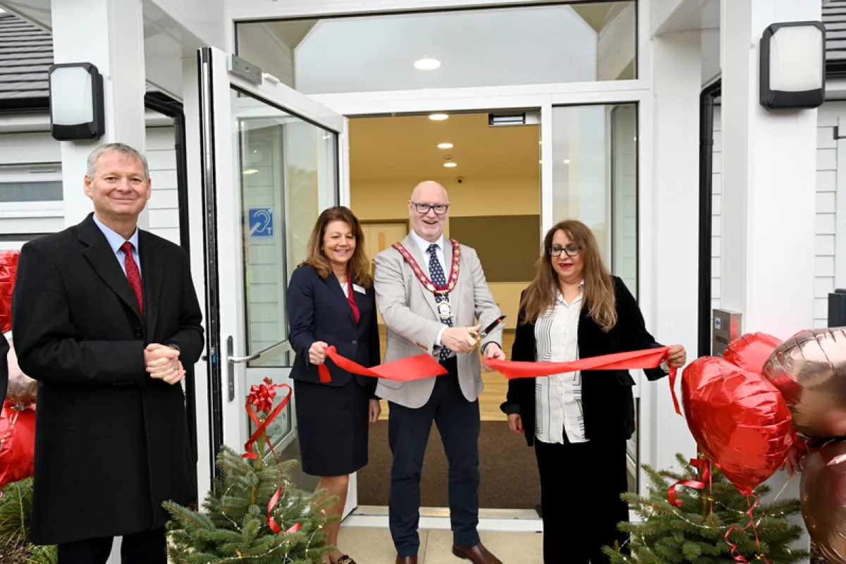 Cutting the ribbon at the entrance of the new community centre