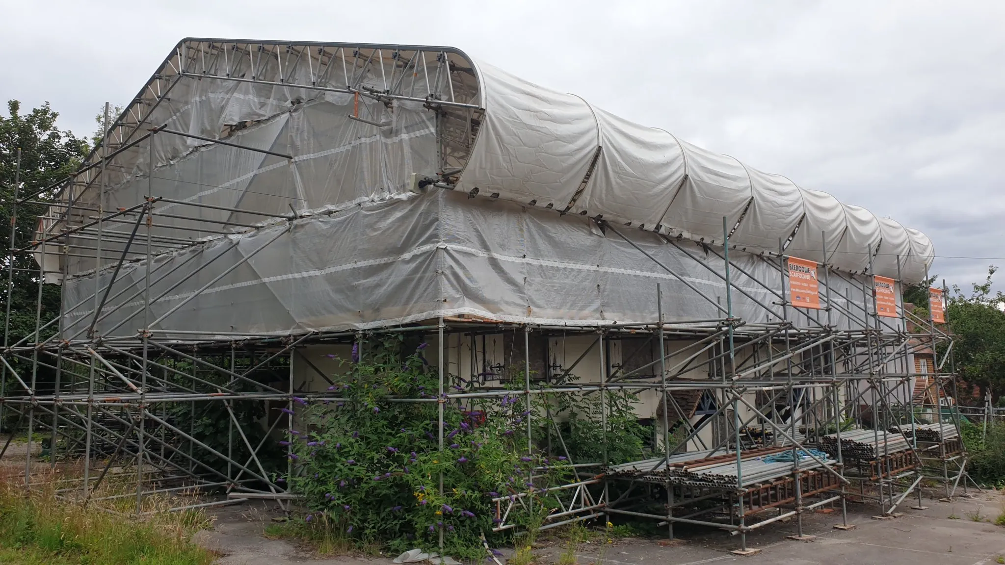 Building with roof covered in plastic