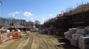 Hawley Park Farm construction site showing progress of buildings and scaffolding over houses