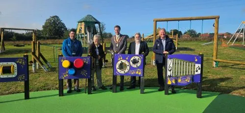 Councillors and staff standing by the play equipment in the new Whitewater Meadows play area