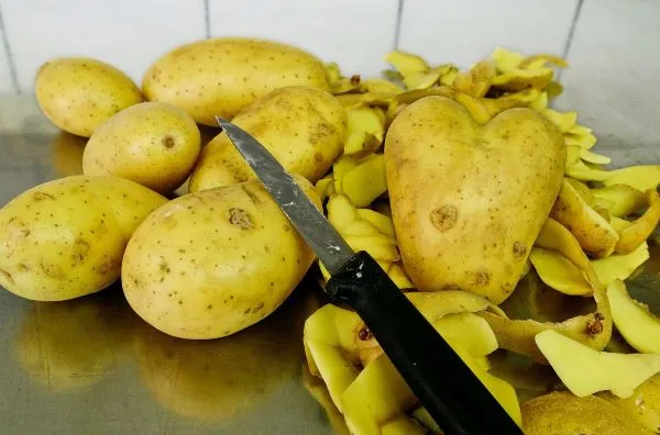 Potato peelings on kitchen side